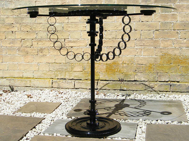 Glass table created from recycled metal