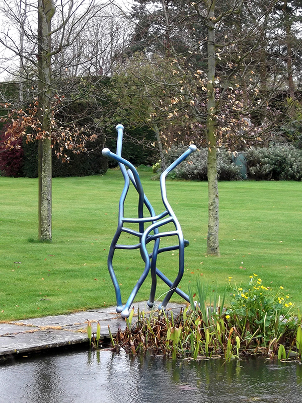 Out of the blue sculpture beside pond